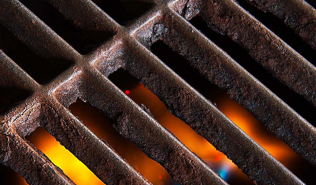 A,Gas,Grill,With,Open,Flames,Below,The,Rusty,Iron